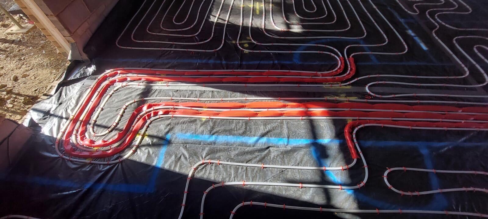 Multiple underfloor heating circuits laid across a room